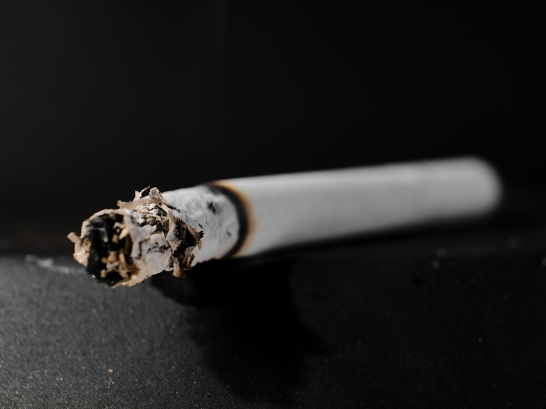 a lit cigarette in an ashtray